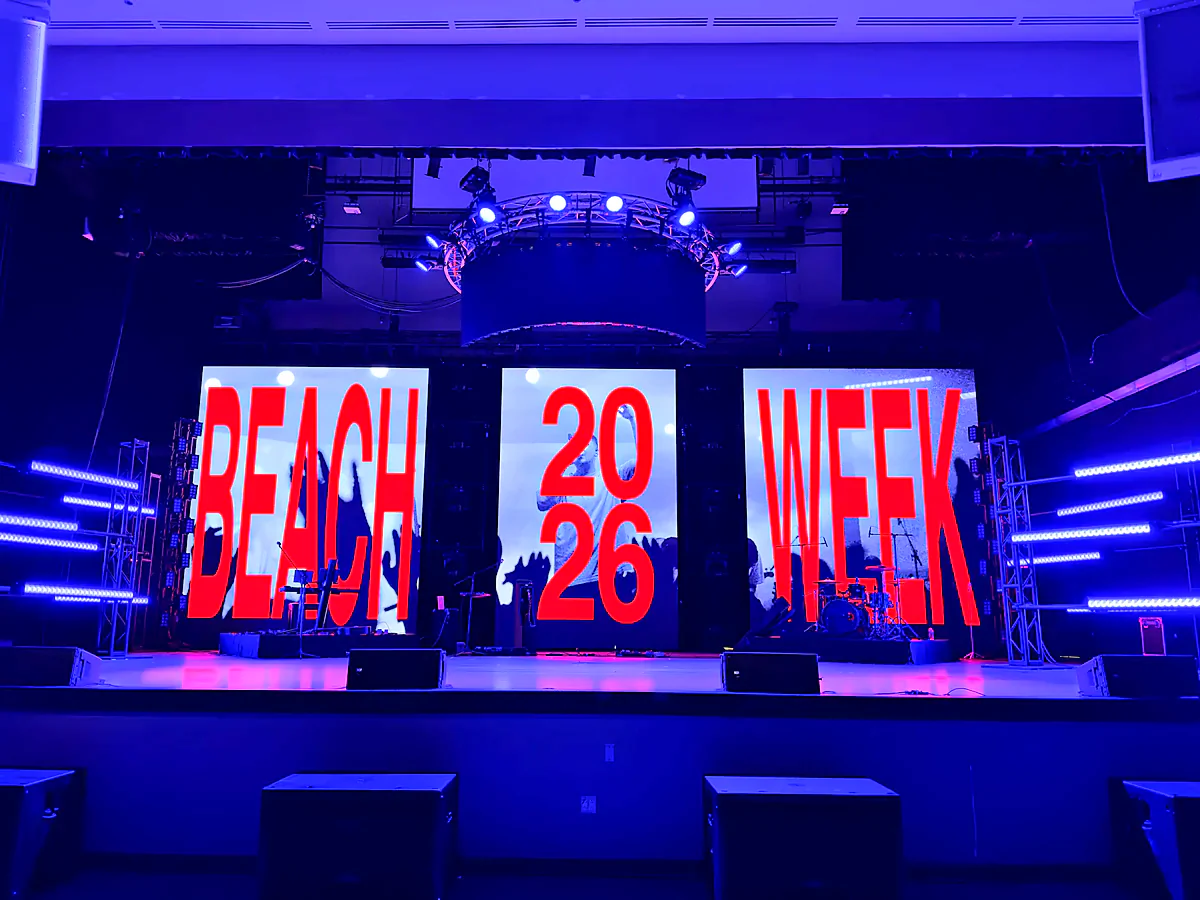 Beach Week 2026 stage: three-panel LED wall reading BEACH 2026 WEEK under a curved truss halo