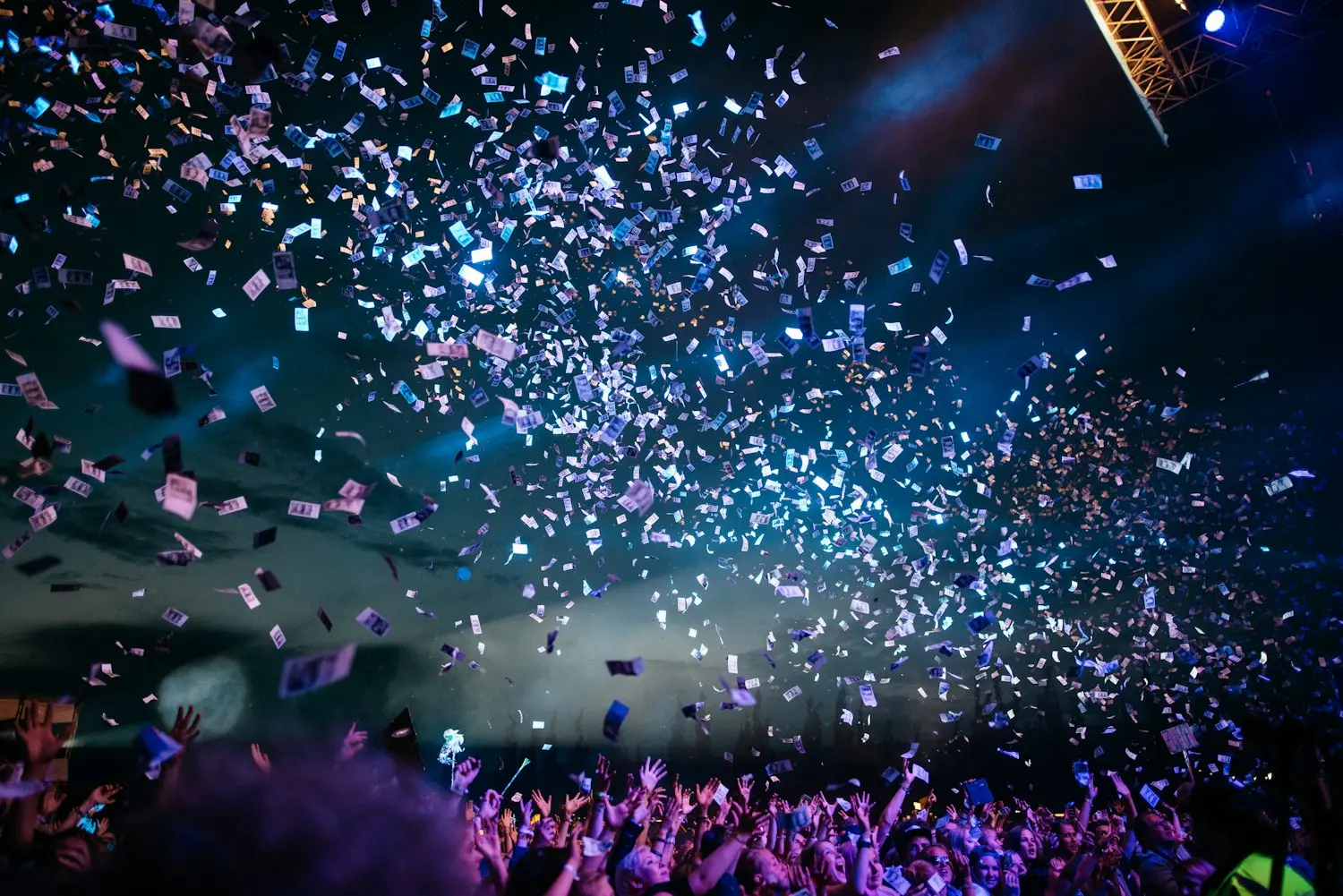 Confetti falling over a night crowd at an outdoor brand activation