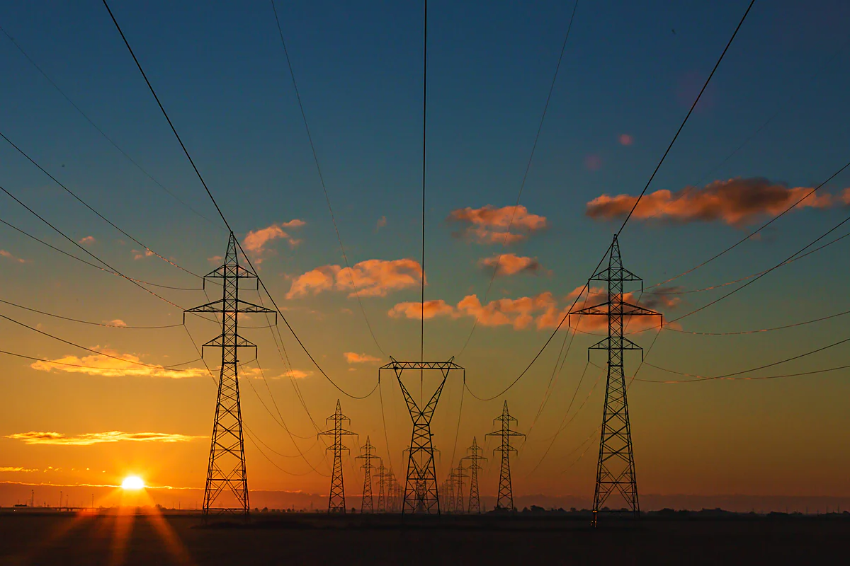 High-voltage transmission towers at dusk