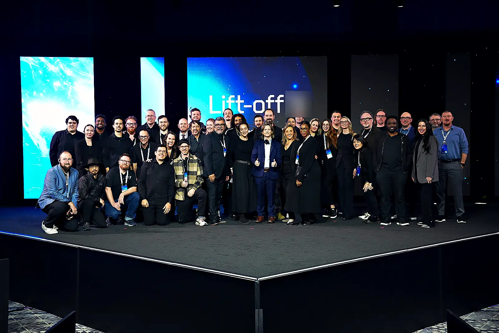 The production crew gathered on the finished general-session stage in front of the event's space-themed LED backdrop