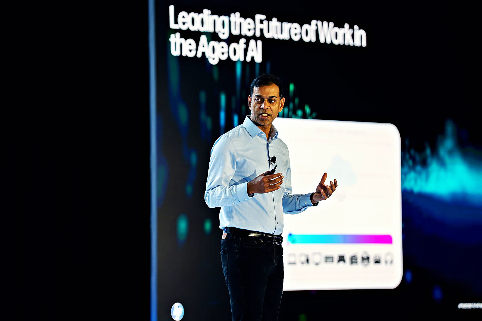 Keynote speaker presenting in front of the LED wall showing Leading the Future of Work in the Age of AI