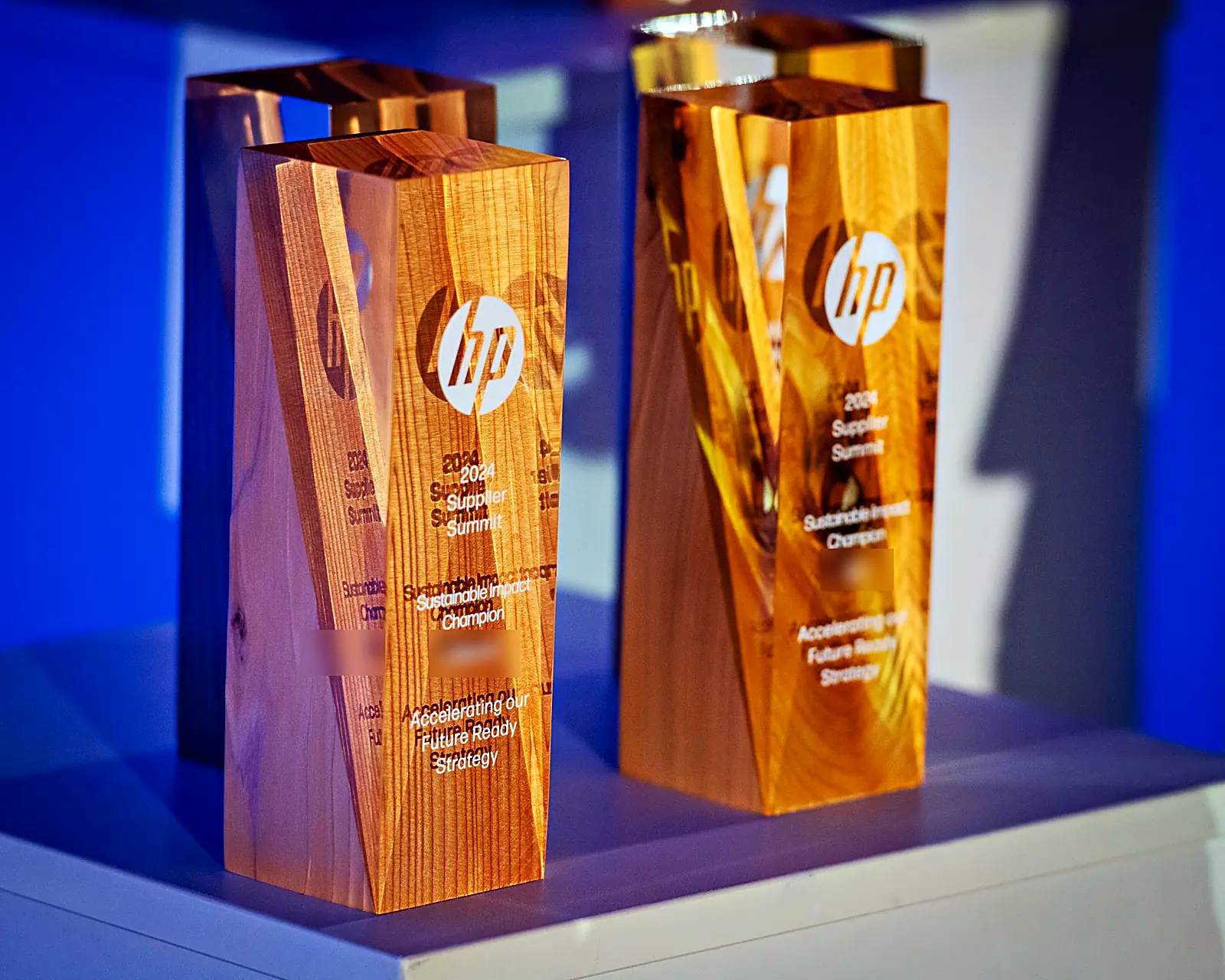 Custom wooden summit awards, laser-etched and backlit in blue