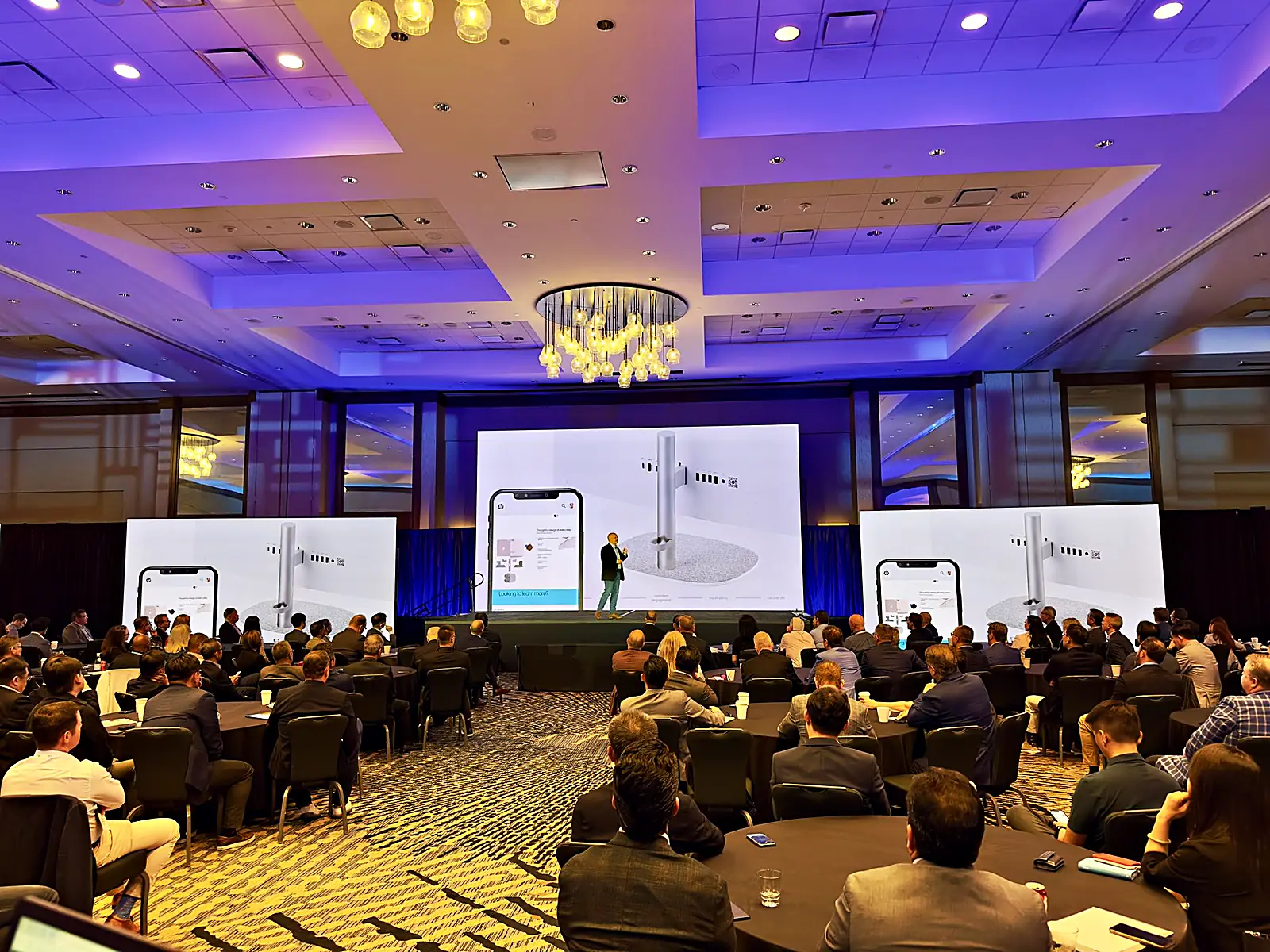 The summit ballroom dressed: chandeliers over the room in a purple wash