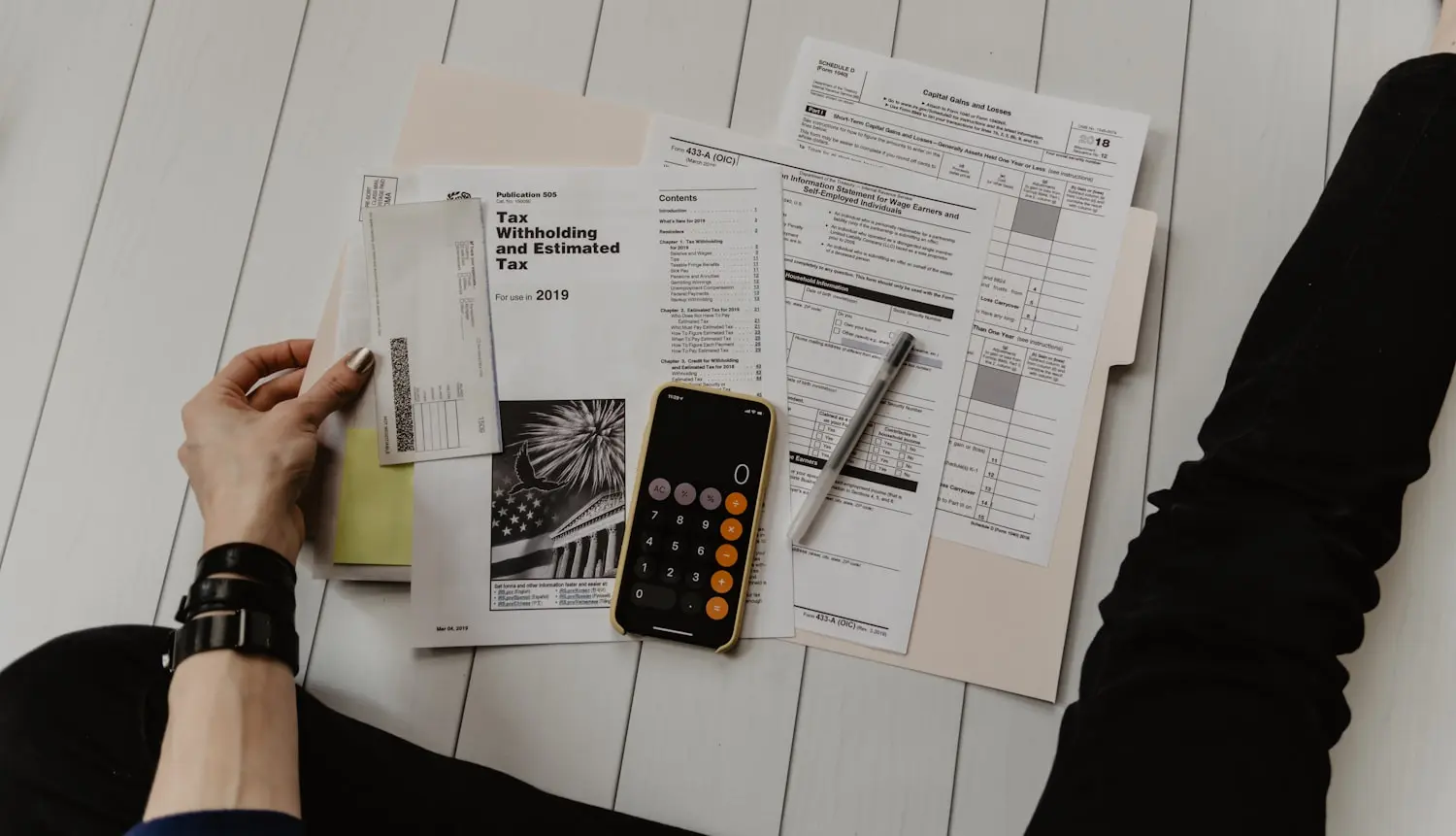 Budget forms and a calculator spread across a desk during RFP planning.