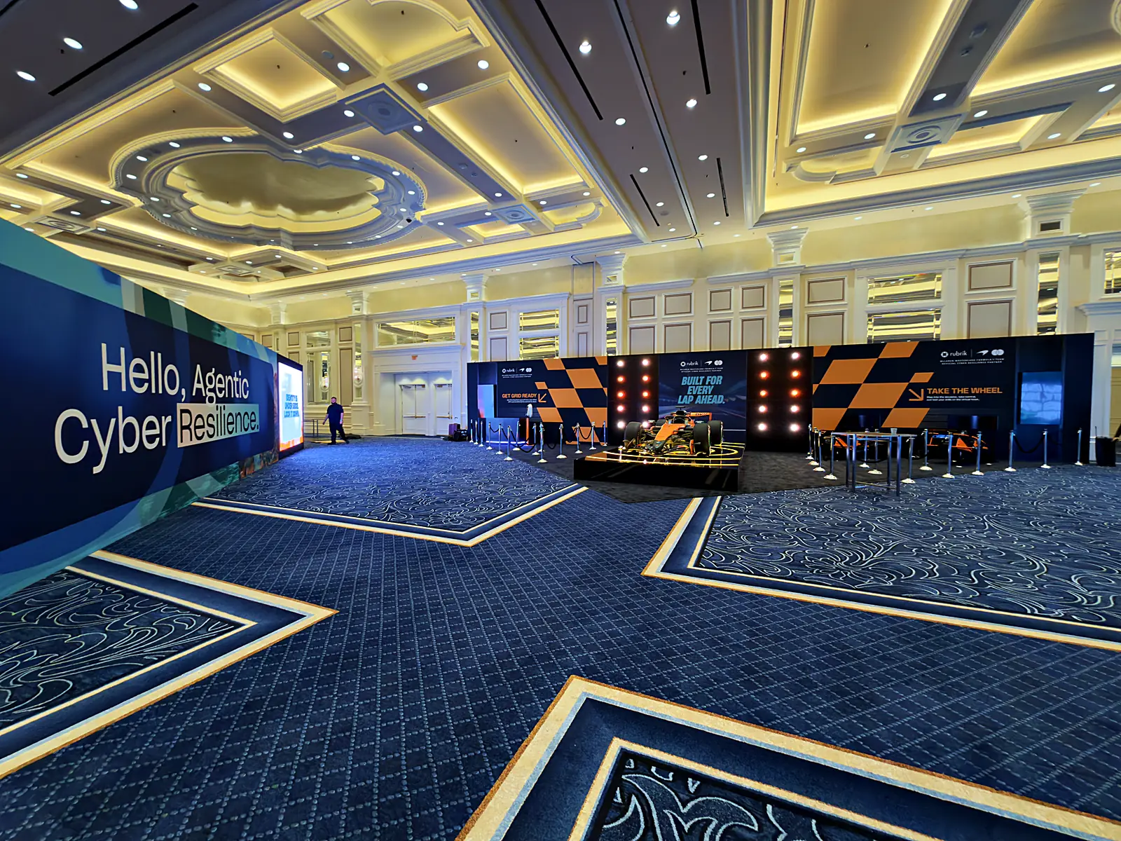 Angled wide of the full F1 activation in the ornate Las Vegas ballroom