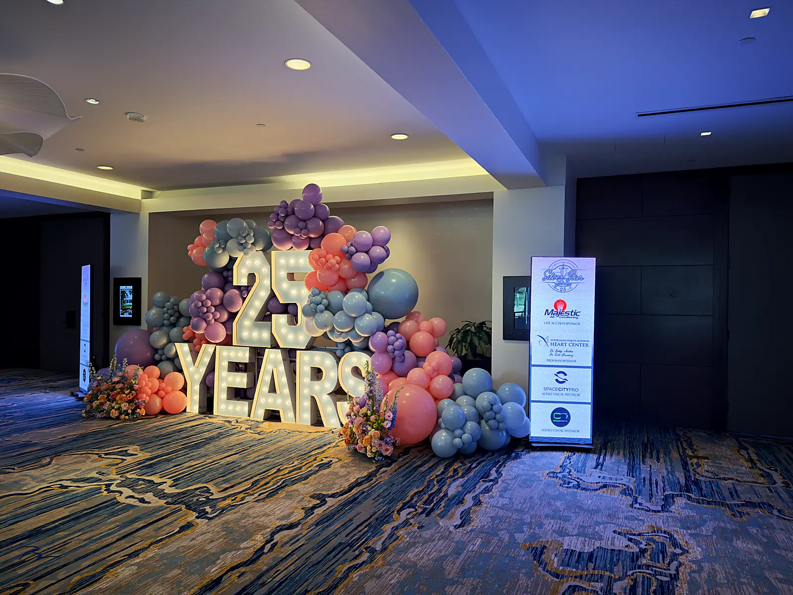 The gala sponsor wall crediting Space City Pro as audio-visual sponsor beside the 25 Years marquee